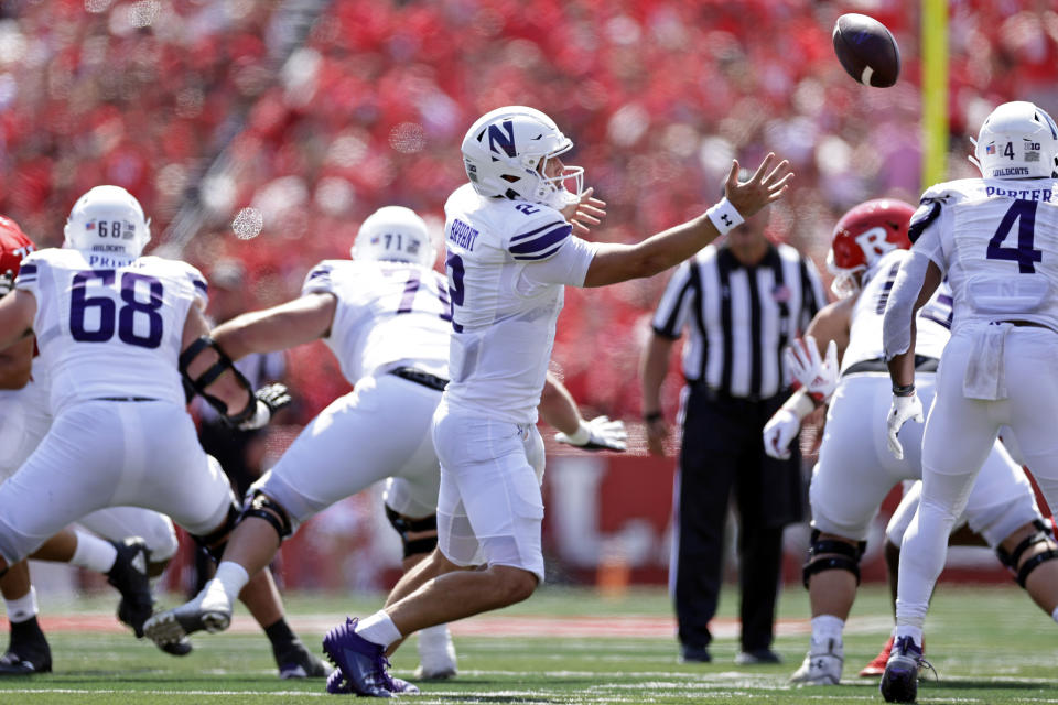 Northwestern quarterback Ben Bryant can't handle a snap against Rutgers during the first half of an NCAA college football game, Sunday, Sept. 3, 2023, in Piscataway, N.J. (AP Photo/Adam Hunger)