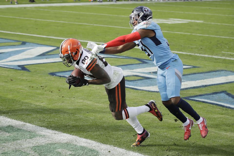 Cleveland Browns wide receiver Jarvis Landry (80) catches a touchdown pass ahead of Tennessee Titans free safety Kevin Byard (31) in the first half of an NFL football game Sunday, Dec. 6, 2020, in Nashville, Tenn. (AP Photo/Ben Margot)