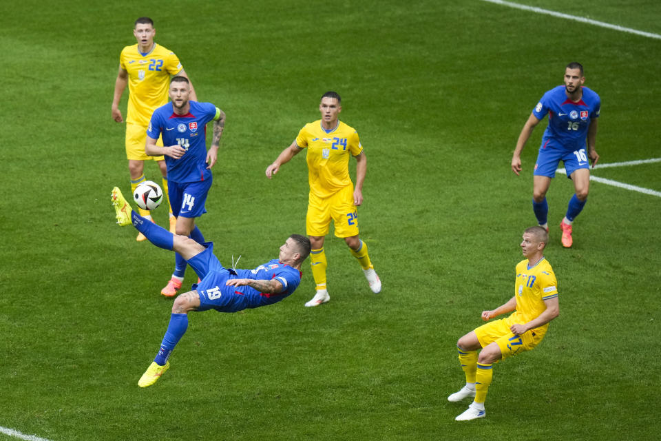 Slovakia's Juraj Kucka, bottom left, shoots during a Group E match between Slovakia and Ukraine at the Euro 2024 soccer tournament in Duesseldorf, Germany, Friday, June 21, 2024. (AP Photo/Alessandra Tarantino)