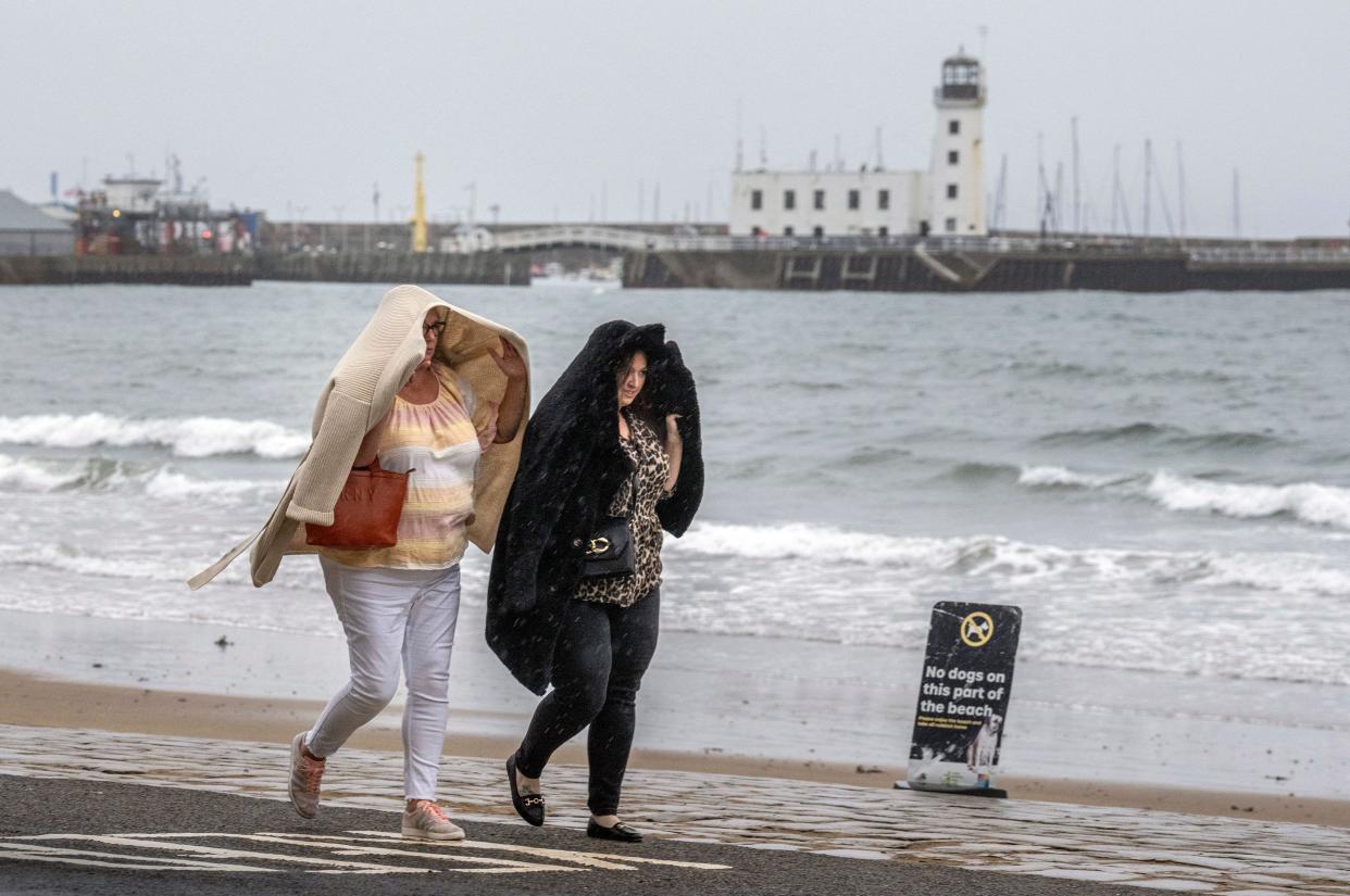 People walk along the sea front in Scarborough, North Yorkshire. Weather warnings will come into force as the UK and Ireland brace for the arrival of Storm Agnes, which will bring damaging winds and big stormy seas. Agnes, the first named storm of the season, will affect western regions of the UK and Ireland, with the most powerful winds expected on the Irish Sea coasts. Picture date: Wednesday September 27, 2023.