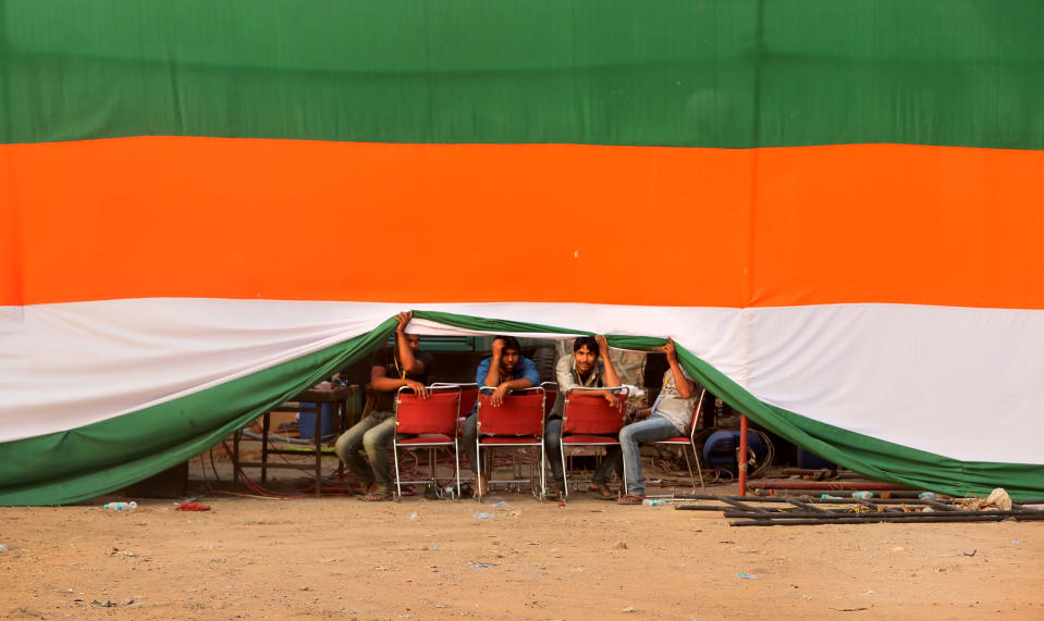 Congress party supporters look out after India's ruling Congress party vice president Rahul Gandhi election rally, in New Delhi, India,Sunday, April 6, 2014. (AP Photo /Manish Swarup)