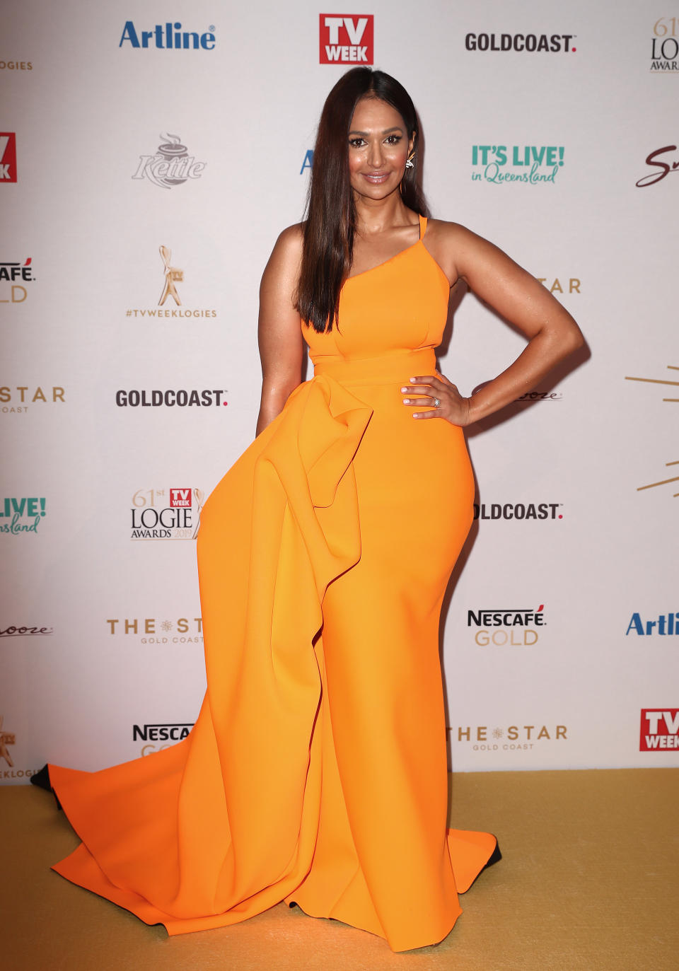 Neighbours star Sharon Johal arrives at the 2019 Logie Awards in a tangerine Cappellazzo Couture dress. Photo: Getty