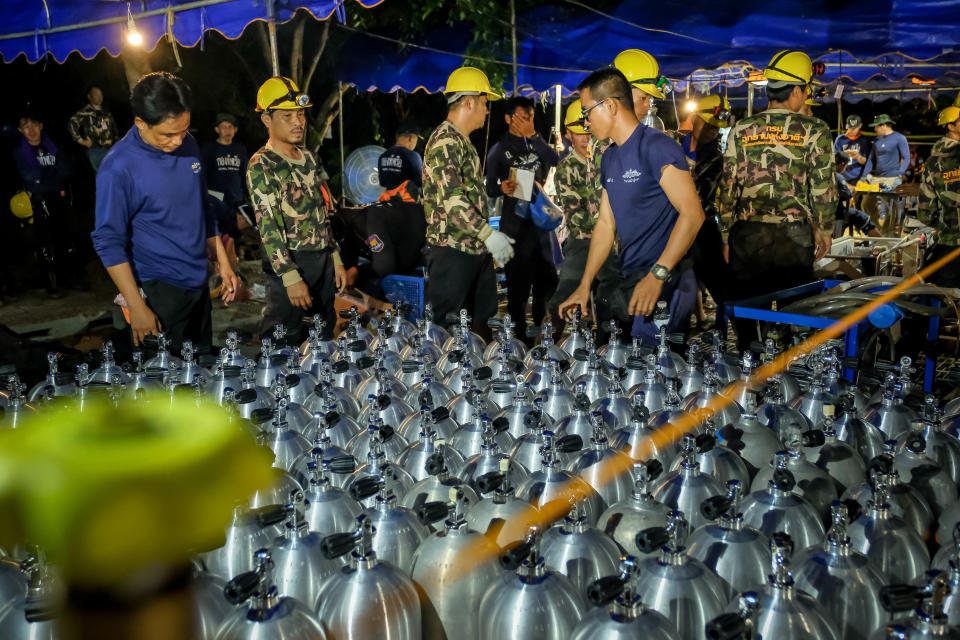 <p>Scuba tanks are delivered for Thai navy SEAL rescuers on July 01, 2018, in Chiang Rai, Thailand. Rescuers looked for alternative ways into a flooded cave, and U.S. forces and British divers joined the search. (Photo: Linh Pham/Getty Images) </p>