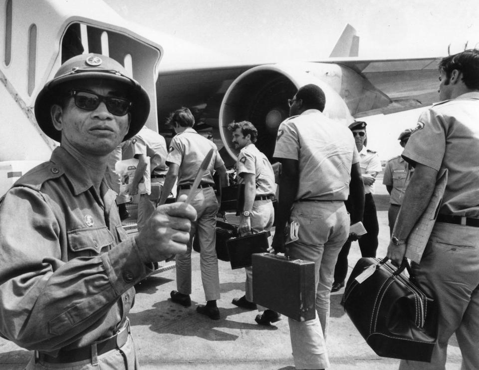 A Viet Cong observer of the Four Party Joint Military Commission counts U.S. troops as they prepare to board jet aircraft at Saigonís Tan Son Nhut airport, March 28, 1973.