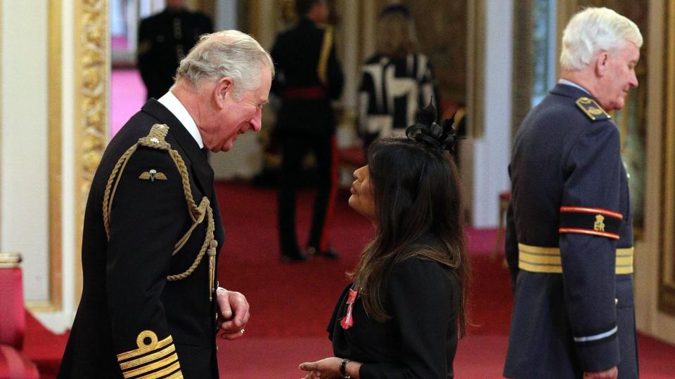 Nisha Katona being given her MBE by the King