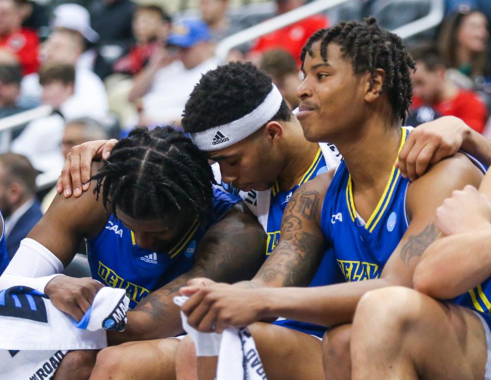 Delaware's Jameer Nelson Jr., (center) sits between seniors Ryan Allen (left) and Kevin Anderson in the final moments of Delaware's 80-60 loss to Villanova in the first round of the NCAA tournament at PPG Paints Arena in Pittsburgh, Pa., Friday, March 18, 2022.