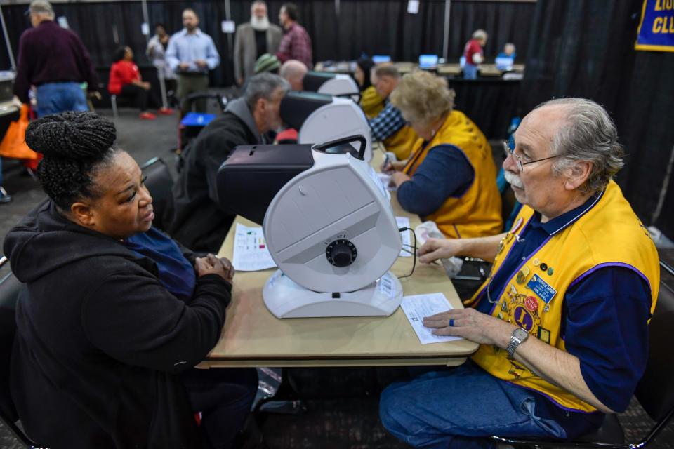 Rayetta Madison of Evansville gets her eye examined by Don Baker with the Eastside Lions Club during the 2019 Homeless Connect of Southwest Indiana event. This year's Homeless Connect will take place Thursday in Downtown Evansville.