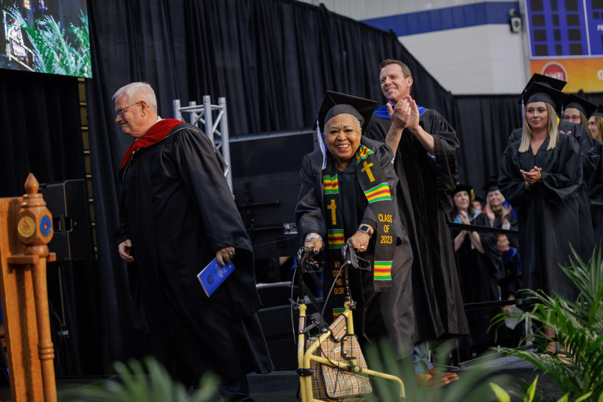 Janice Hall, 81, walking to accept her college degree at Bethel University, which was decades in the making. (Peter Ringenberg for Bethel University) 