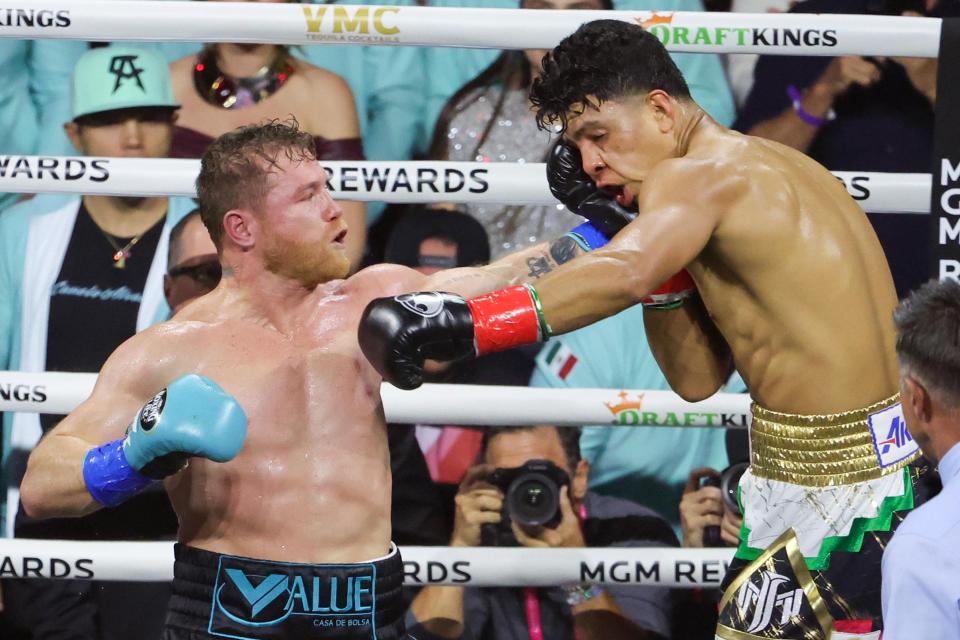 LAS VEGAS, NEVADA - MAY 04: Canelo Alvarez (L) hits Jaime Munguia during their undisputed super middleweight championship fight at T-Mobile Arena on May 04, 2024 in Las Vegas, Nevada. Alvarez retained his titles in a unanimous decision. (Photo by Ethan Miller/Getty Images)
