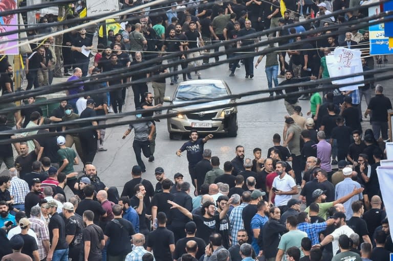 People in Beirut's southern suburbs react after a reported explosion during the funeral of those killed when hundreds of paging devices exploded across Lebanon the previous day (Fadel ITANI)