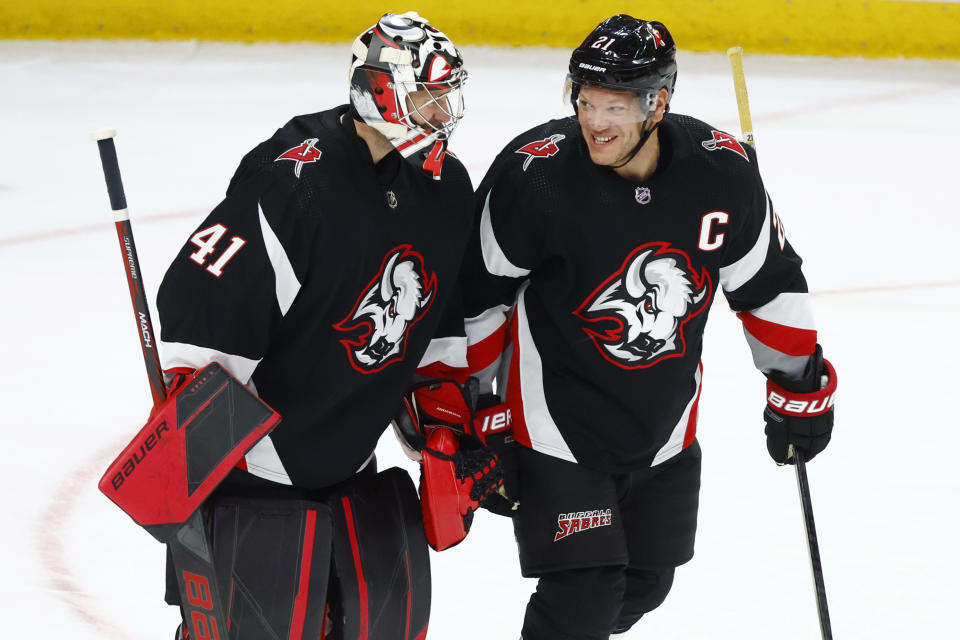 Buffalo Sabres goaltender Craig Anderson (41) and right winger Kyle Okposo (21) celebrate a 6-0 victory following the third period of an NHL hockey game against the Los Angeles Kings, Tuesday, Dec. 13, 2022, in Buffalo, N.Y. (AP Photo/Jeffrey T. Barnes)