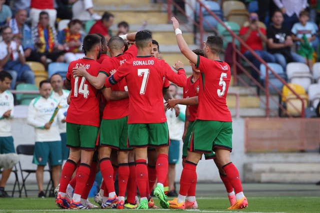 Portugal's players embrace in a group to celebrate Joao Felix's goal against Republic of Ireland