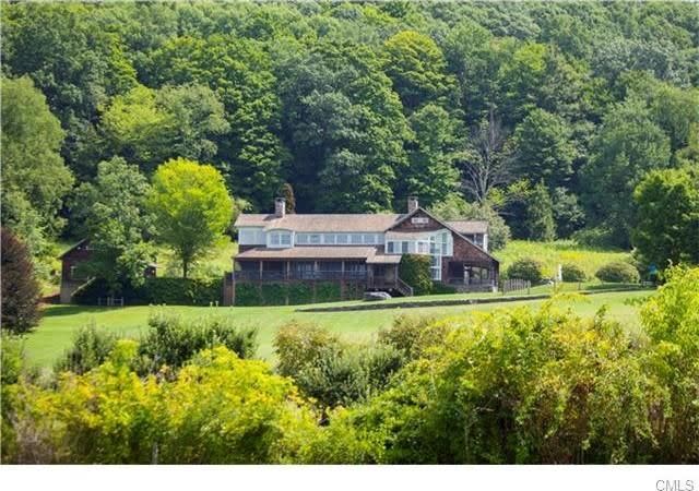 <p>The classic shingle and stone home rests on 72-acres of lush greenery. It also sits next to a property owned by Pollan’s parents. (Realtor.com) </p>