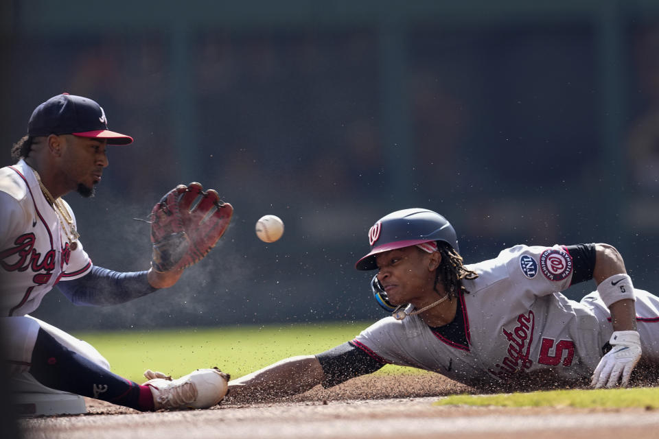 Washington Nationals' CJ Abrams (5) steals second base ahead of the throw to Atlanta Braves second baseman Ozzie Albies (1) in the first inning of a baseball game, Sunday, Oct. 1, 2023, in Atlanta. (AP Photo/John Bazemore)
