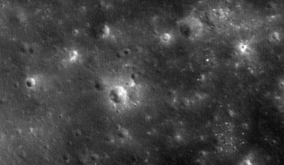 The crater gouged out when NASA's LADEE probe crashed intentionally into the moon on April 18, 2014 is visible as a small white smudge to the upper right of the large central crater in this image captured by the space agency's Lunar Reconnaissa