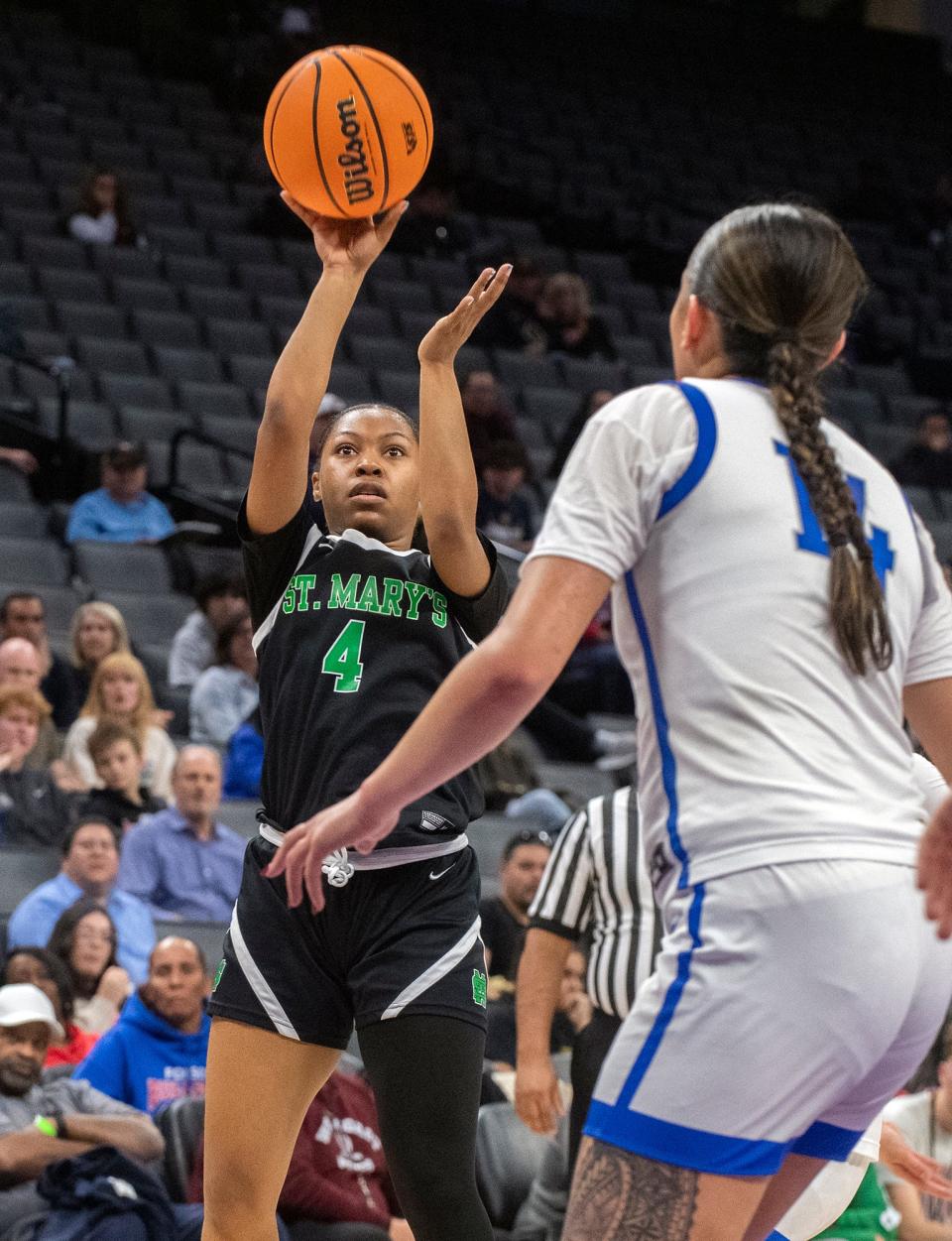 St. Mary's Nyah Buntun, left, shoots over Folsom's Kamryn Mafua during the Sac-Joaquin Section girls basketball championship game at Golden One Center in Sacramento on Feb. 21. 2024. St. Mary's won 57-51.