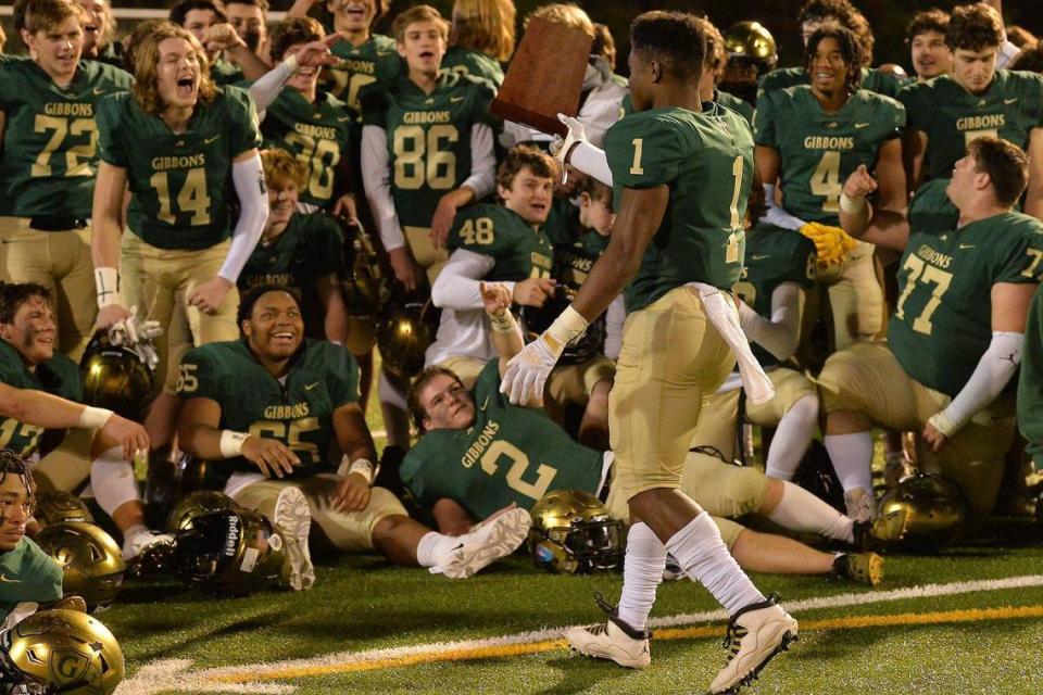 The Cardinal Gibbons football team reacts as Will Mason (1) walks over the East Regional Final trophy after their defeat of Rolesville. The Cardinal Gibbons Crusaders and the Rolesville Rams met in the NCHSAA 4A East Regional Final in Raleigh, N.C. on December 3, 2021 Steven Worthy/newsobserver.com