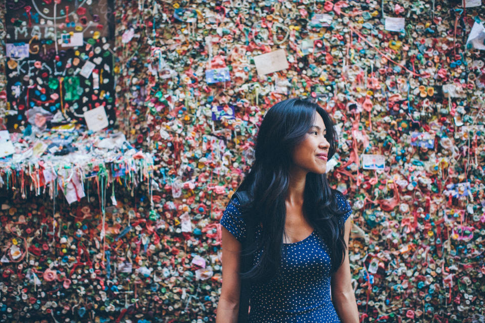 A woman in front of the Gum Wall