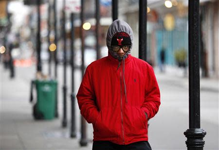 A man walks to work early Wednesday morning in New Orleans, Louisiana January 29, 2014. REUTERS/Jonathan Bachman