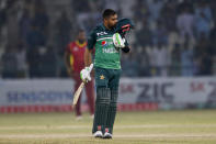 Pakistan's Babar Azam kisses his helmet after scoring century during the first one day international cricket match between Pakistan and West Indies at the Multan Cricket Stadium, in Multan, Pakistan, Wednesday, June 8, 2022. (AP Photo/Anjum Naveed)