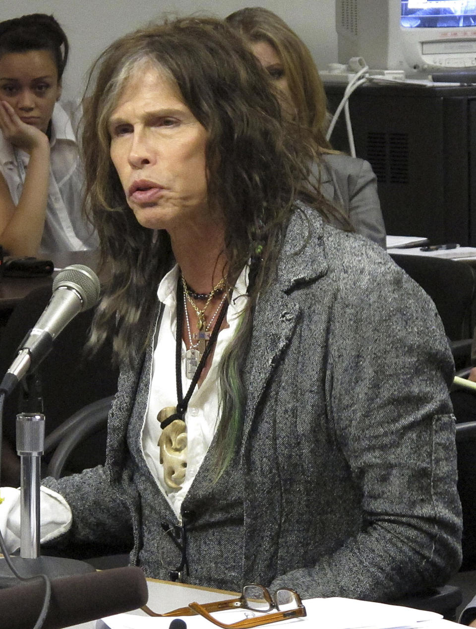 FILE - This Feb. 8, 2013 file photo shows Aerosmith lead singer Steven Tyler testifying on celebrity privacy during a hearing at the Hawaii Capitol in Honolulu. The Hawaii state Senate plans to vote on a bill aimed at protecting celebrities and other public figures from unwanted media attention. The so-called Steven Tyler Act would create a civil violation for people who take photos or videos of others’ private moments. (AP Photo/Oskar Garcia, file)