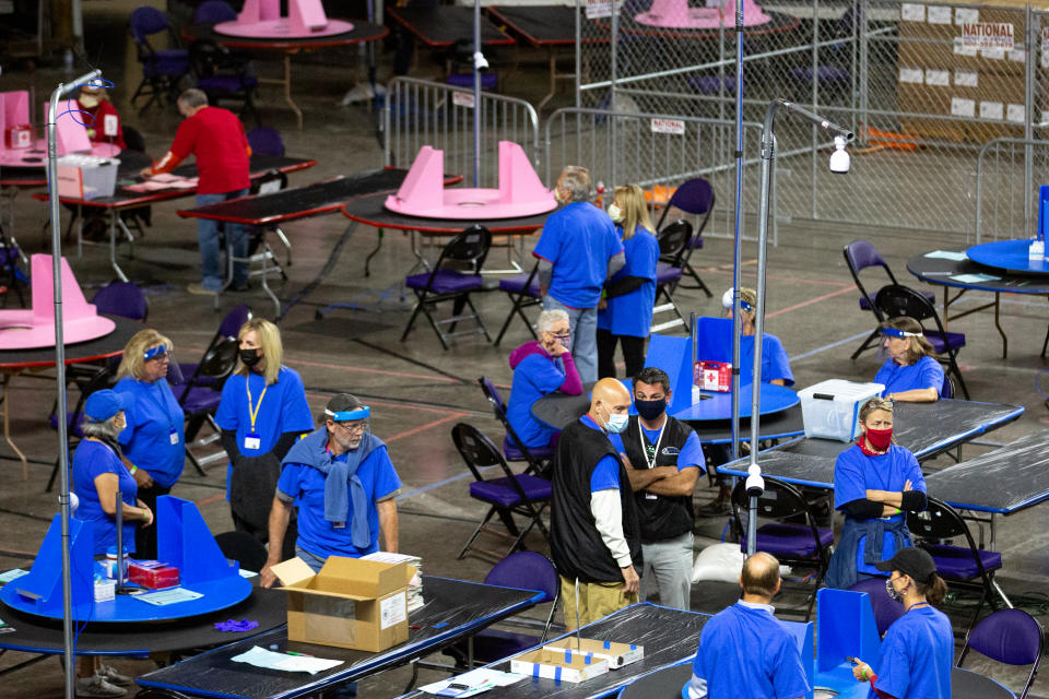 Contractors working for Cyber Ninjas examine ballots from the 2020 general election in Phoenix, May 3, 2021. (Photo by Courtney Pedroza for the Washington Post)