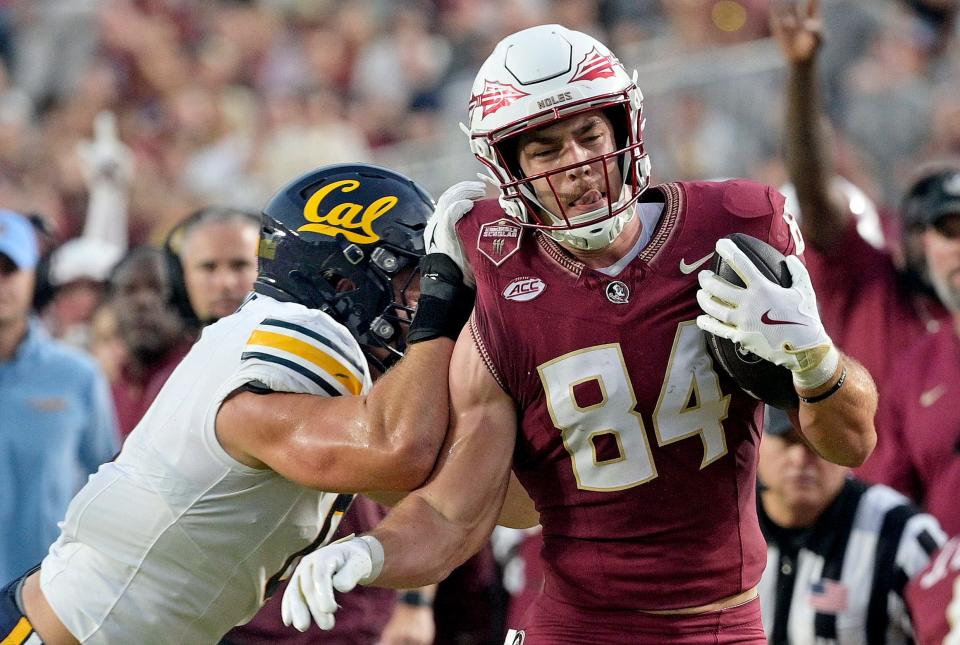 Sep 21, 2024; Tallahassee, Florida, USA; Florida State Seminoles tight end Kyle Morlock (84) is knocked out of bounds during the first half against the California Golden Bears at Doak S. Campbell Stadium. Mandatory Credit: Melina Myers-Imagn Images