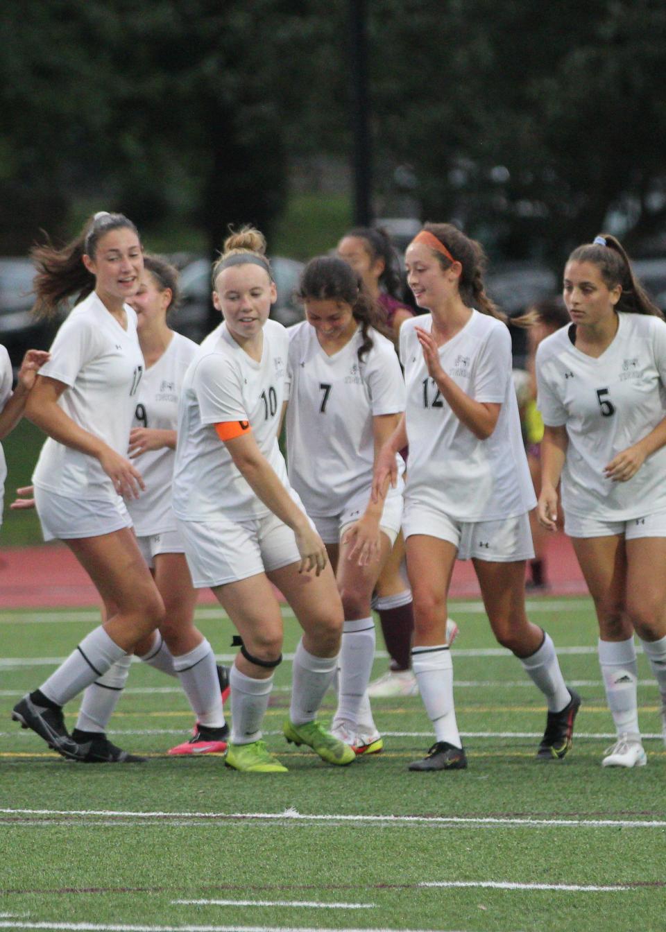 Mamaroneck celebrates with Jessica Bowman (7, center) after her goal during the Tigers' 3-2 overtime win. Bowman had one goal and one assist in the win.