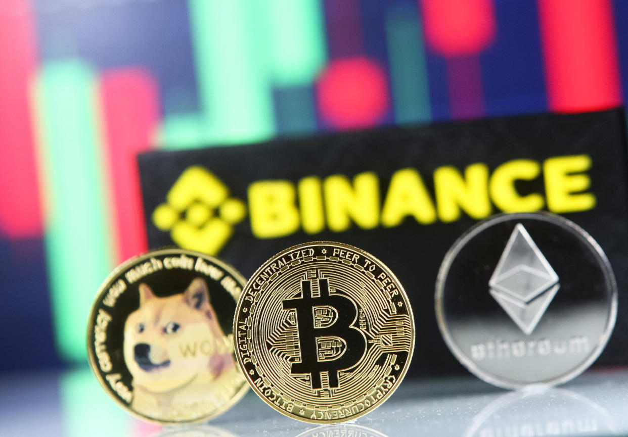 Bitcoin, Dogecoin, Ethereum cryptocurrency coins and Binance cryptocurrency exchange logo are pictured in Kyiv on 08 July, 2021. (Photo by STR/NurPhoto via Getty Images)