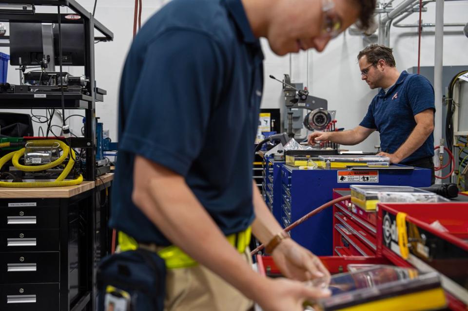 Engineers at the Manufacturing Tech Lab in Fort Worth. The Lockheed lab occupies a government-owned factory that built bombers during World War II. Today, military and civilian staff work there side by side.