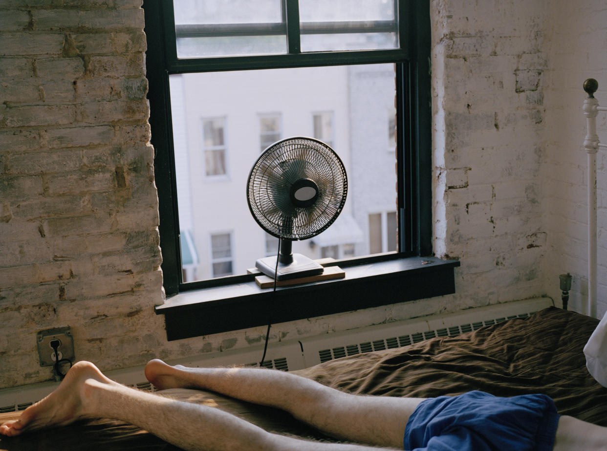 Person sleeping with the fan on in hot weather. (Getty Images)