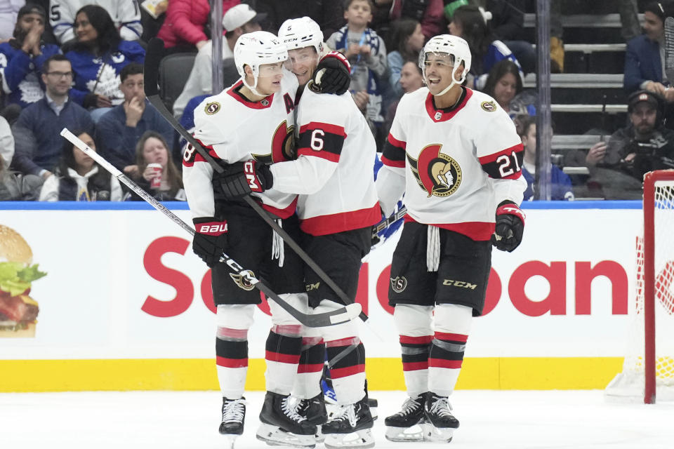 Ottawa Senators' Jakob Chychrun, center, celebrates with teammates after scoring against the Toronto Maple Leafs during the second period of an NHL hockey match in Toronto, on Wednesday, Nov. 8, 2023. (Chris Young/The Canadian Press via AP)