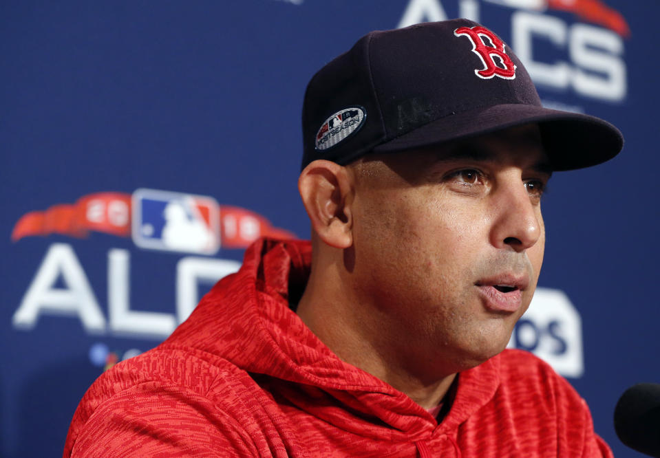 FILE - In this Oct. 11, 2018 file photo Boston Red Sox manager Alex Cora speaks during a news conference at a baseball workout in Boston. Cora spent this season rewarding the support of Jackie Bradley Jr., David Price and the rest of the Boston Red Sox organization with a record-breaking year and a run deep into the playoffs. The rookie manager's accomplishments go further than the baseball diamond, too. Having seen his homeland of Puerto Rico devastated by Hurricane Maria, Cora remains at the forefront of helping the island rebuild. (AP Photo/Elise Amendola, file)