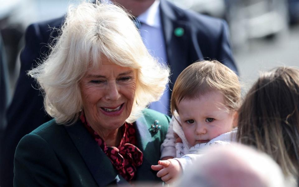 Camilla greets a small child during her walkabout - Russell Cheyne/Reuters