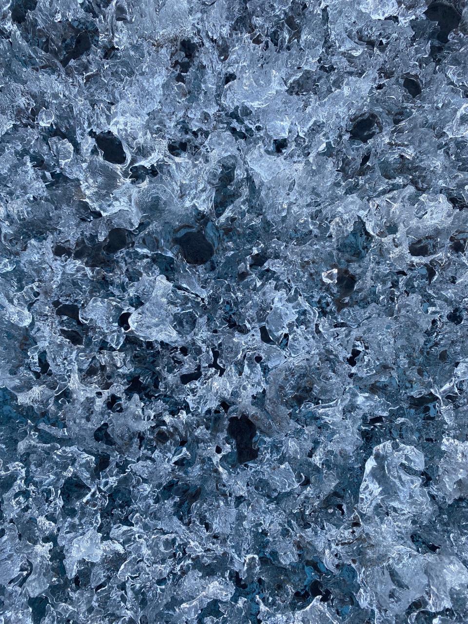 close up of dark ice full of holes