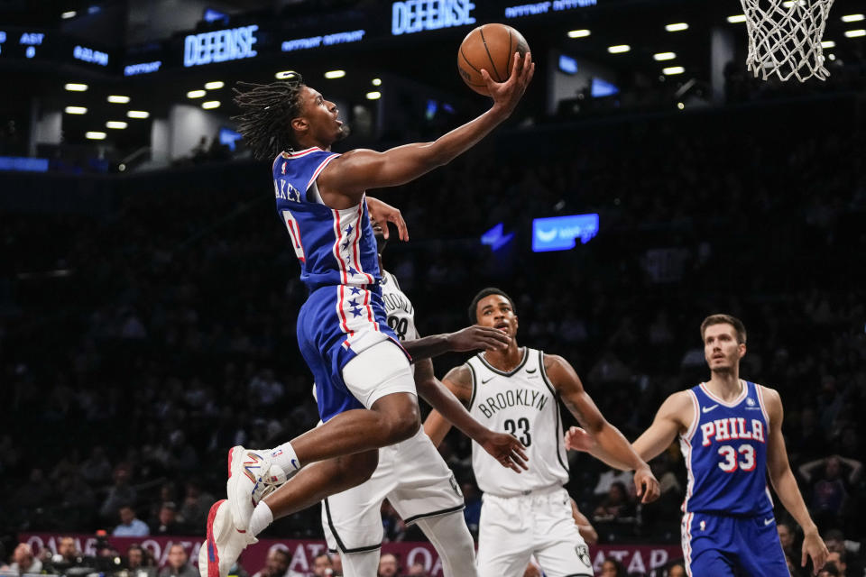 Philadelphia 76ers' Tyrese Maxey, left, drives past Brooklyn Nets' Dorian Finney-Smith, center, and Nic Claxton during the first half of a preseason NBA basketball game Monday, Oct. 16, 2023, in New York. (AP Photo/Frank Franklin II)