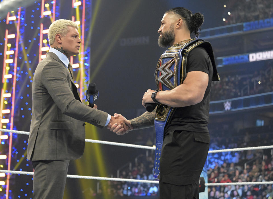 Cody Rhodes, left, and Roman Reigns meet in the center of the ring during an episode of WWE Smackdown on March 3, 2023, in Washington. Rhodes and Reigns will be in the main event of WrestleMania 39 on Sunday, April 2, 2023, in Los Angeles. (WWE via AP)