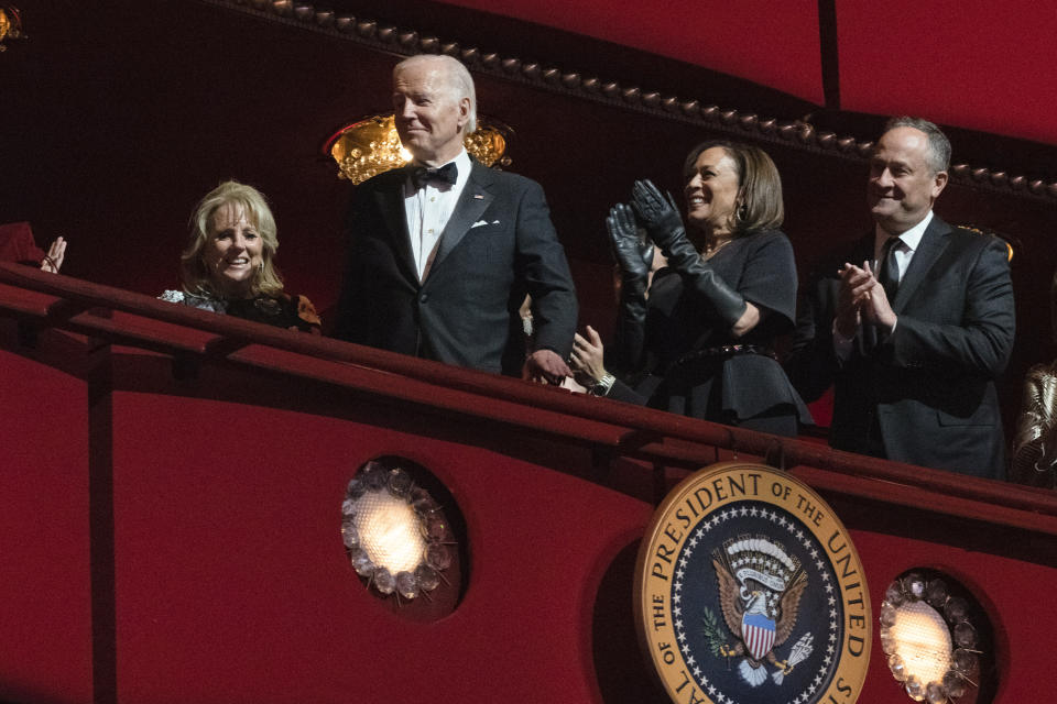 President Joe Biden and first lady Jill Biden arrive at the 45th Kennedy Center Honors at the John F. Kennedy Center for the Performing Arts in Washington, Sunday, Dec. 4, 2022. Vice President Kamala Harris and her husband Doug Emhoff, applaud at right. (AP Photo/Manuel Balce Ceneta)