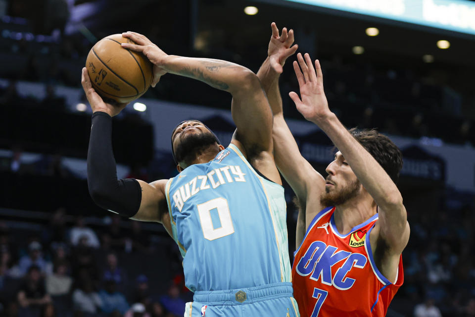 Charlotte Hornets forward Miles Bridges (0) looks to shoot against Oklahoma City Thunder forward Chet Holmgren during the first half of an NBA basketball game in Charlotte, N.C., Sunday, April 7, 2024. (AP Photo/Nell Redmond)