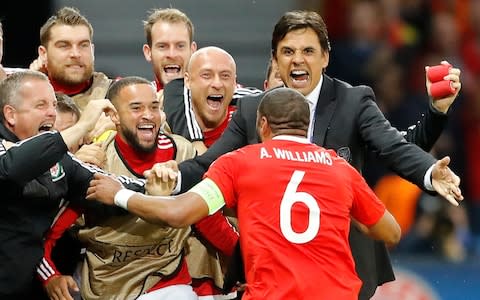 Chris Coleman congratulates Ashley Williams during the Belgium quarter-final - Credit: AP