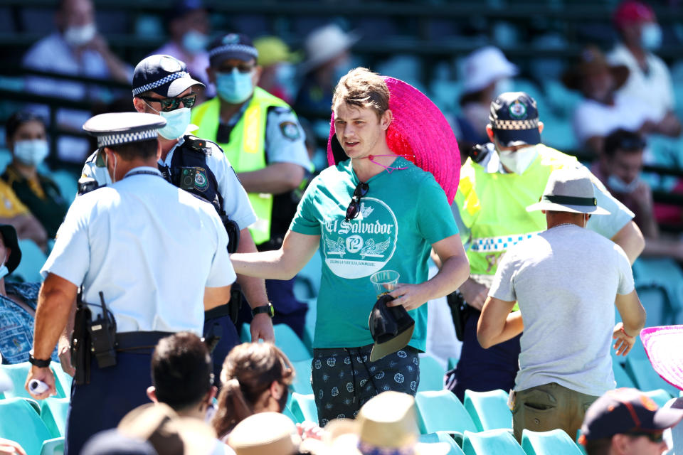 SYDNEY, AUSTRALIA - JANUARY 10: Police speak to spectators following a complaint from Mohammed Siraj of India that stopped play during day four of the Third Test match in the series between Australia and India at Sydney Cricket Ground on January 10, 2021 in Sydney, Australia. (Photo by Cameron Spencer/Getty Images)