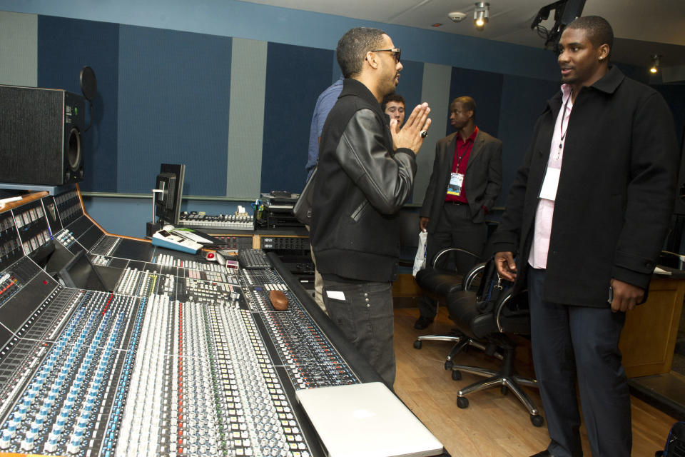 In this photo taken, Tuesday, Feb. 28, 2012, musician Ryan Leslie, left, meets with former NFL football player Darren Howard at the first-ever NFL Business of Music Boot Camp at New York University’s Clive Davis Institute of Recorded Music in New York. This week, the league offered an assist to current and former players like Howard who are trying to find their footing in a business that can be just as brutal and unforgiving as football. (AP Photo/Charles Sykes)