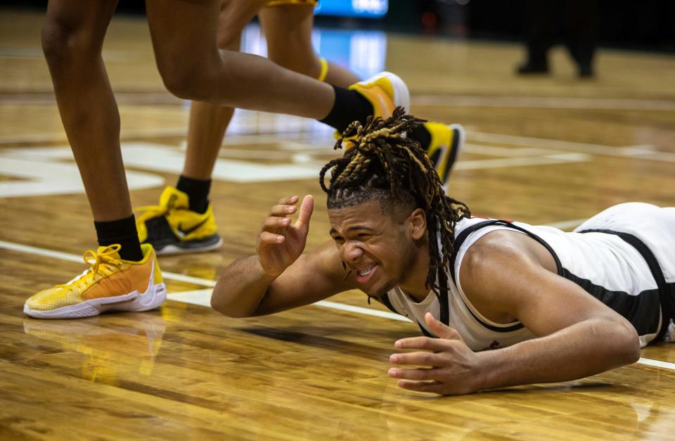 Orchard Lake St. Mary's Trey McKenney lies on the court after making contact with a North Farmington defender during the MHSAA Div. 1 state finals at the Breslin Center in East Lansing on Saturday, March 16, 2024.