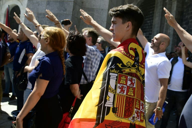 Un joven cubierto con la bandera de la España franquista hace el saludo fascista durante la protesta celebrada en julio de 2019.