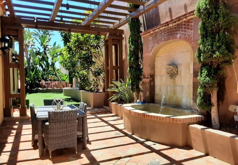 The Mediterranean-style estate is nestled on a cul-de-sac with panoramic city views, according to the Zillow listing. The dining room opens to a patio with fireplace, side yard and fountain.