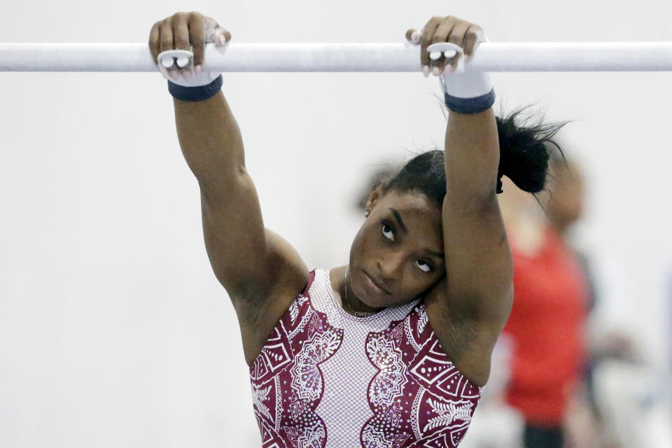 Simone Biles pauses before her turn on the parallel bars during training at the Stars Gymnastics Sports Center in Katy, Texas, Monday, Feb. 5, 2024. Biles begins preparations for the Paris Olympics when she returns to competition at the U.S. Classic in Hartford, Connecticut on Saturday. Biles, who cited mental health concerns while removing herself from several competitions at the Tokyo Olympics, says she is better prepared for the pressure competing presents this time around. (AP Photo/Michael Wyke)