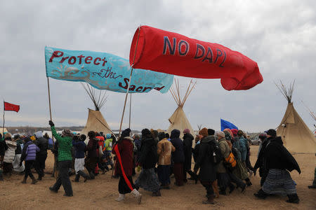 People march in Oceti Sakowin camp during a protest against plans to pass the Dakota Access pipeline near the Standing Rock Indian Reservation, near Cannon Ball, North Dakota, U.S. November 27, 2016. REUTERS/Stephanie Keith