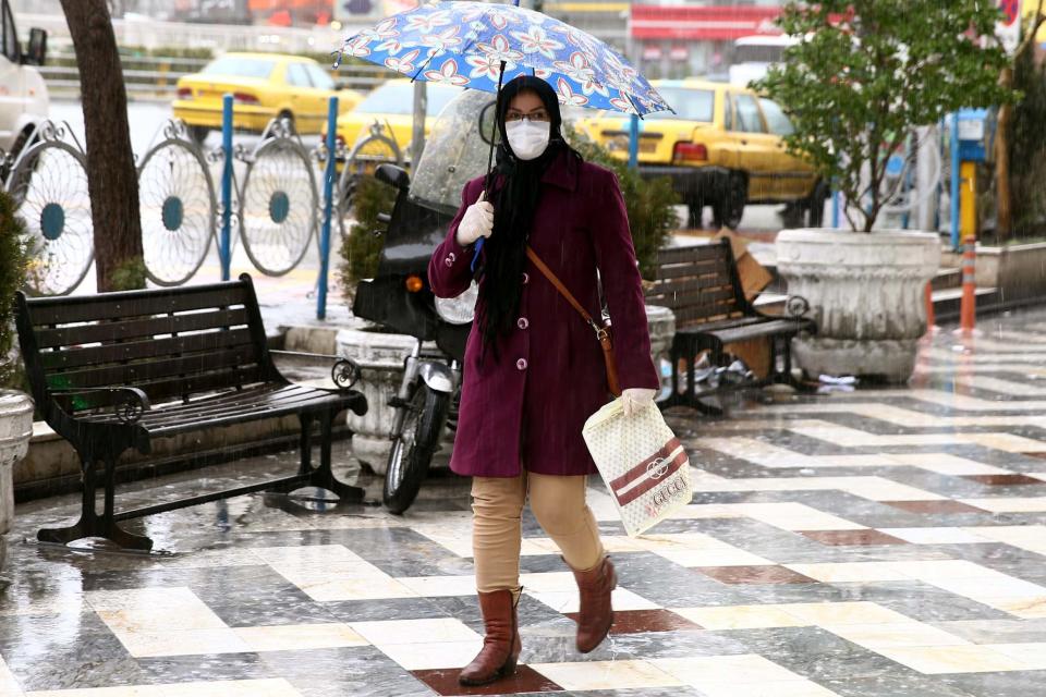 An Iranian woman wears a protective mask to prevent contracting coronavirus (VIA REUTERS)