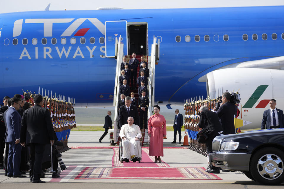 Pope Francis is received by the Foreign Minister of Mongolia, Batmunkh Battsetseg, right, as he arrives at Ulaanbaatar's International airport Chinggis Khaan, Friday, Sept. 1, 2023. Pope Francis is traveling to Mongolia to encourage one of the world's smallest and newest Catholic communities. It's the first time a pope has visited the Asian country and comes at a time when the Vatican's relations with Mongolia's two powerful neighbors, Russia and China, are once again strained. (AP Photo/Andrew Medichini)