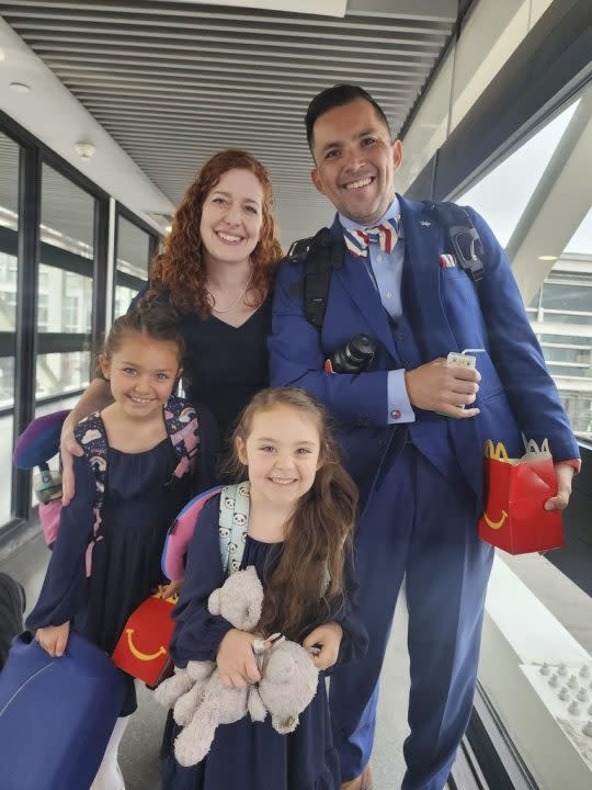 In this undated image provided by Constanza Del Rio/Nos Buscamos, Jimmy Thyden poses for a photo with his wife Johannah, and their two daughters, Ebba Joy, 8, left, and Betty Grace, 5, center, at the Valdivia Airport in Valdivia, Chile. Jimmy Thyden and his family went on a trip to Valdivia to meet his biological mother. (Constanza Del Rio/Nos Buscamos via AP)